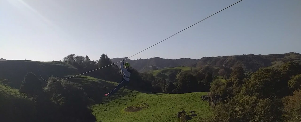 Flying high on long ziplines at Waitomo Caves, one of the best things to do in Hamilton only a 1 hr drive away
